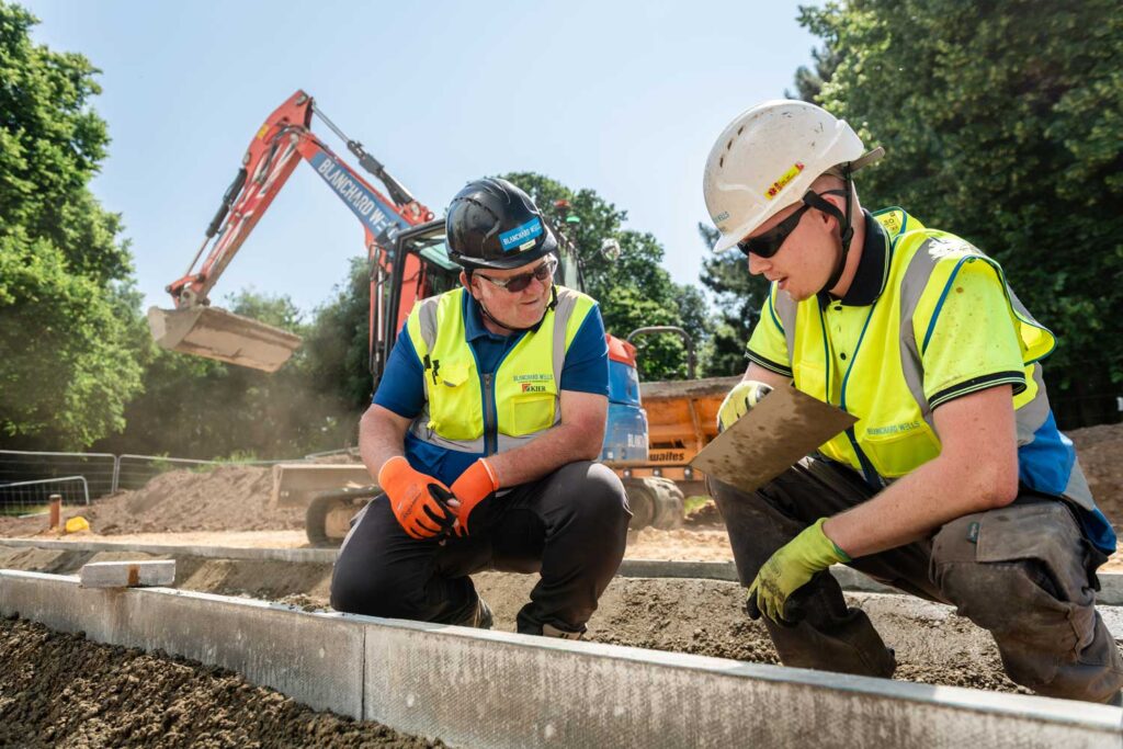 An instructor teaching a CETC apprentice about groundworks.